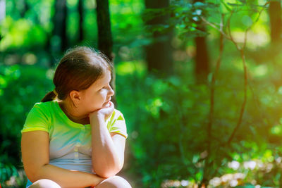 Girl looking away in forest