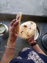 Cropped image of woman holding chapattis