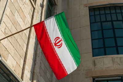 Low angle view of flag against building