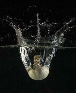 Close-up of splashing water against black background