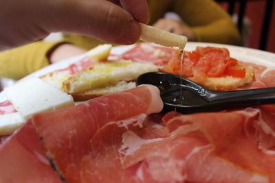 Close-up of hand holding meat