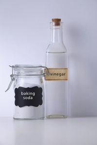 Close-up of glass bottles with text against white background