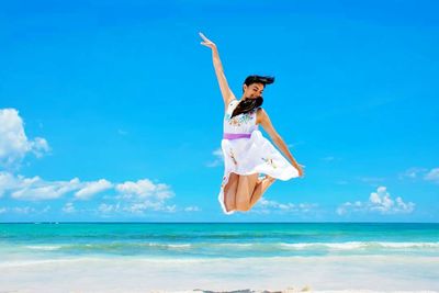 Woman jumping on beach