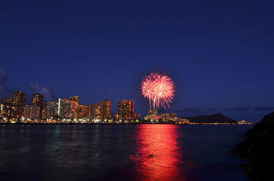 Firework display over city at night