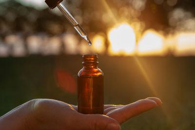 Close-up of hand holding bottle