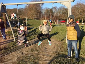 Full length portrait of happy friends playing in park