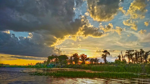 Scenic view of lake against sky during sunset