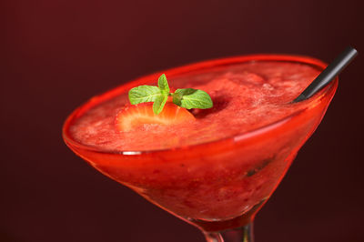 Close-up of drink on glass against black background