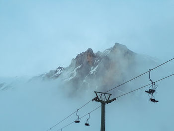 Low angle view of ski lift against sky