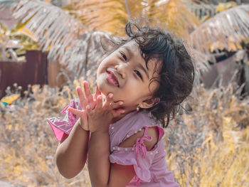 Portrait of cute girl lying on field