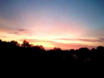 Silhouette trees against sky during sunset