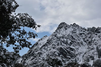 Low angle view of snowcapped mountains against sky