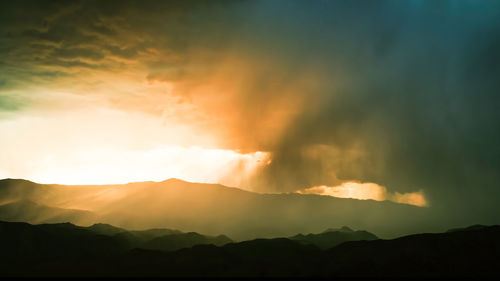 Scenic view of mountains against sky during sunset.cloudy, clodus of rain, balck color of clouds,