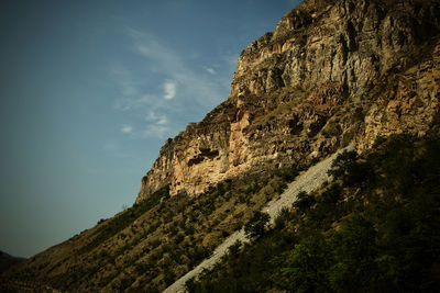 Low angle view of rock formations against sky