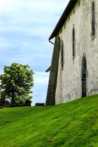 Built structure on field against sky