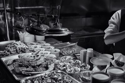 Cropped image of vendor with street food at market