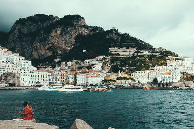 Panoramic view of sea and buildings against sky