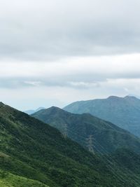 Scenic view of mountains against cloudy sky