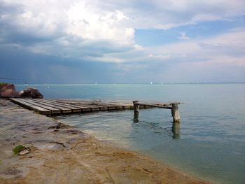 Scenic view of sea against cloudy sky