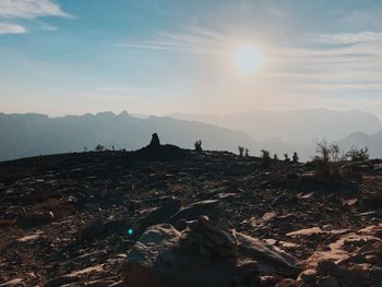 Scenic view of rocks against sky during sunset