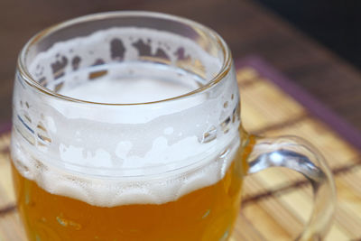 Close-up of beer glass on wooden table