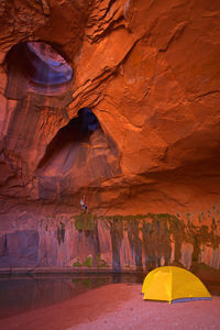 Man rappelling into cave at escalante's giant staircase