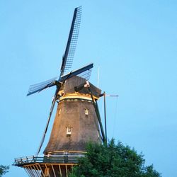 Low angle view of traditional windmill against sky