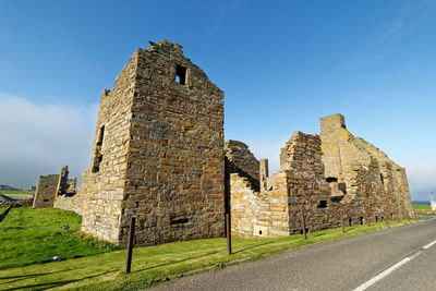 Low angle view of old building against blue sky