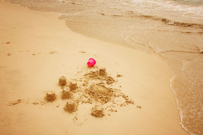 High angle view of pink toy on beach