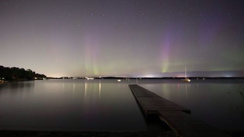 Scenic view of lake against sky at night