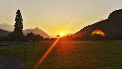 Scenic view of field against sky during sunset