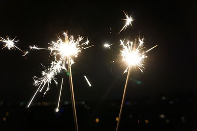 Low angle view of firework display at night