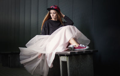 Young woman sitting on table