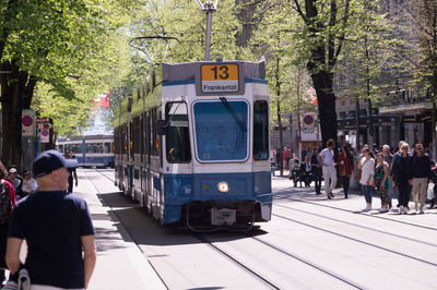 Group of people on railroad tracks in city
