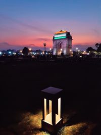 India gate, delhi illuminated with tri-colour indian flag under sunset