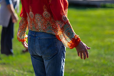 Midsection of woman standing on field