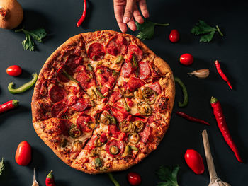 Close up of pizza slices against black background