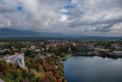 High angle view of river by townscape against sky