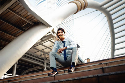 Full length portrait of a smiling young man