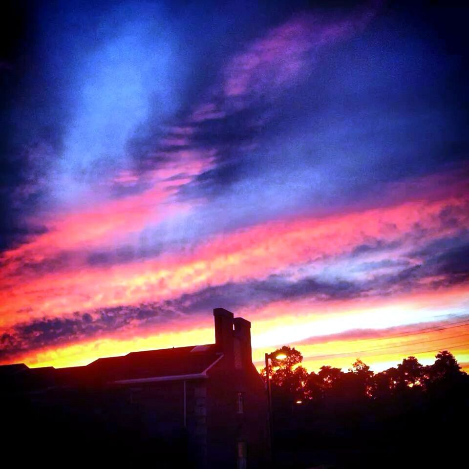 sunset, silhouette, sky, orange color, built structure, cloud - sky, architecture, dramatic sky, building exterior, beauty in nature, low angle view, scenics, tree, tranquility, nature, cloud, tranquil scene, cloudy, outdoors, no people