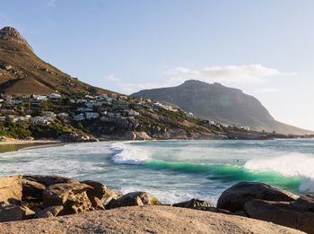 Scenic view of sea and mountains against sky