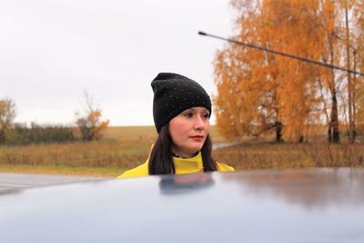 Portrait of young woman in autumn leaves