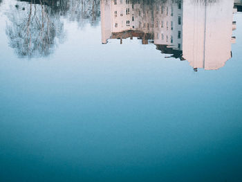 High angle view of buildings reflecting on lake