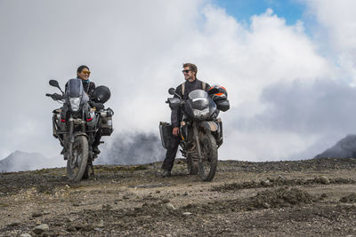 Couple on touring motorbikes at the pass of abra de malaga (4316 m)