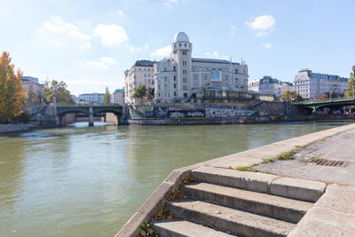 Bridge over river against buildings in city