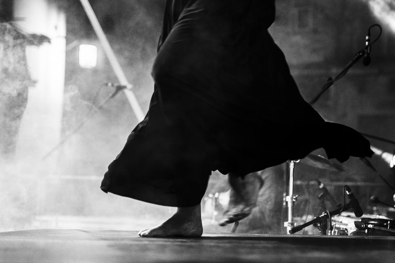 LOW SECTION OF WOMAN STANDING AT NIGHTCLUB