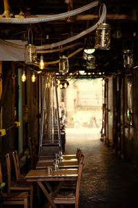 Empty chairs and tables in illuminated building