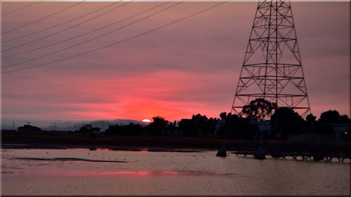View of calm countryside lake at sunset