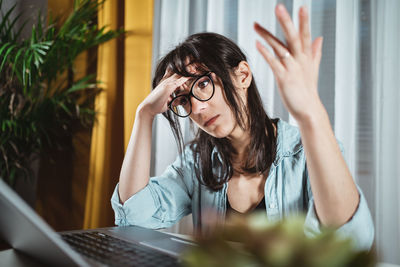 Exhausted businesswoman sitting at home