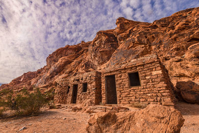 Low angle view of old ruin building against cloudy sky at valley of fire